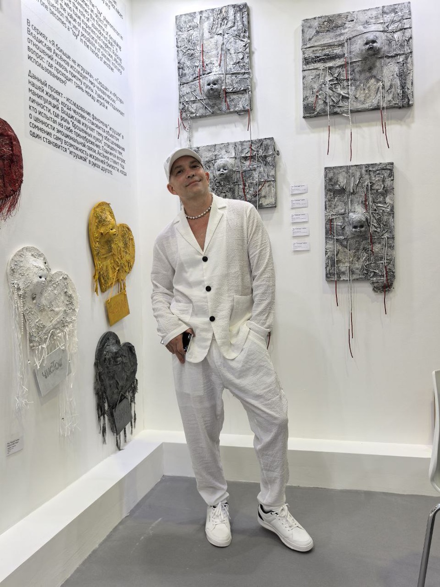 Владислав Аксёнов у своего стенда с работами на World Art Dubai 2025