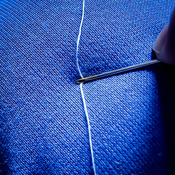 Размещаем нитку на ровной поверхности. Обратите внимание: у меня иголка с малюсеньким ушком - и это вообще никак не влияет на процесс.