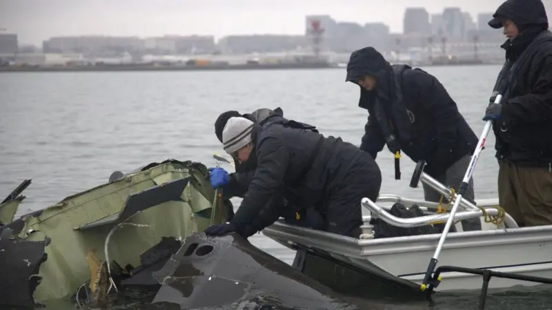 Расследователи поднимают из реки обломки вертолета. Фото: Getty Images