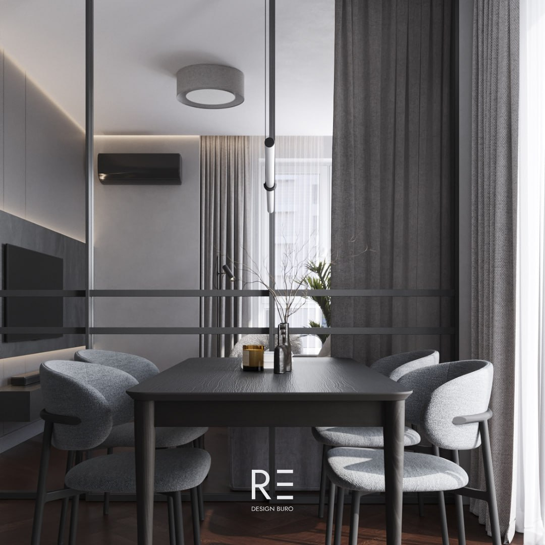 Плотная штора в гостиной дополняет стеклянную перегородку и отделяет часть комнаты