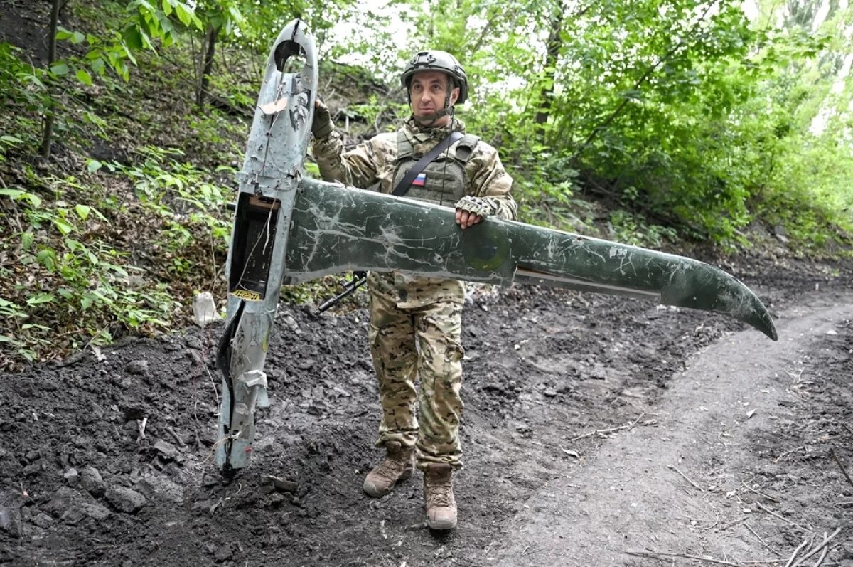    Военнослужащий ВС РФ со сбитым украинским БПЛА Shark mini