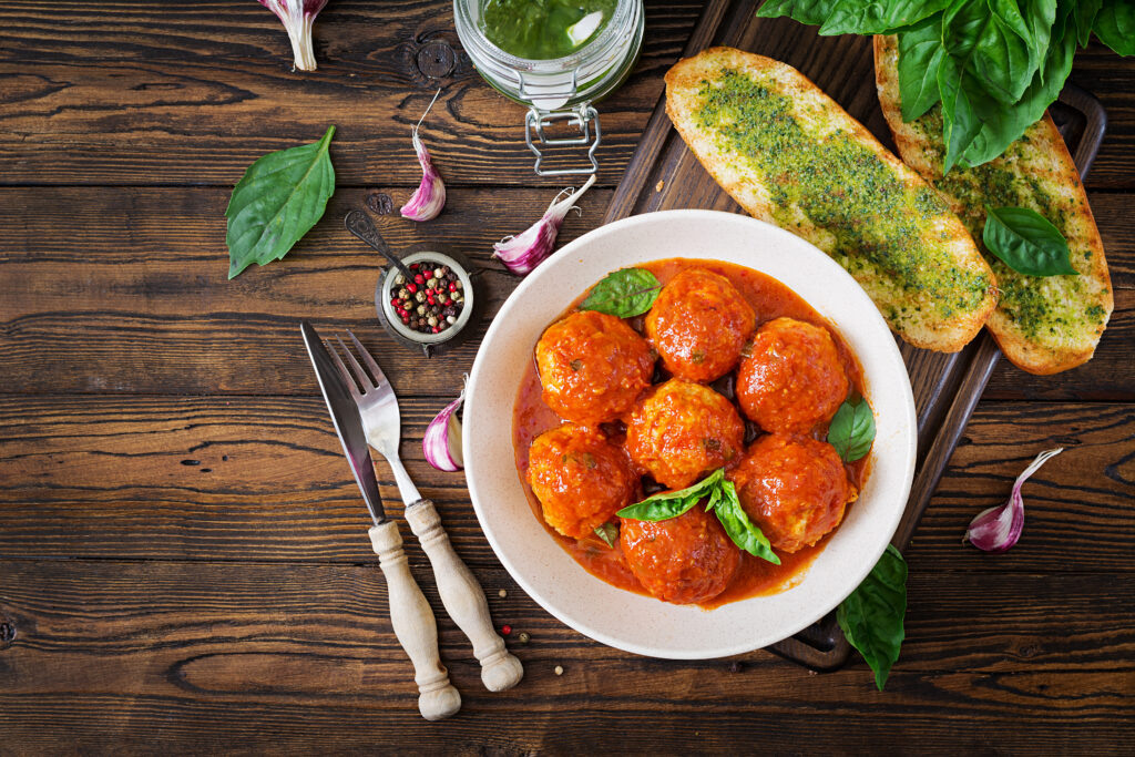   Meatballs in tomato sauce and toast with basil pesto. Dinner. Tasty food. Top view. Flat lay Журналист
