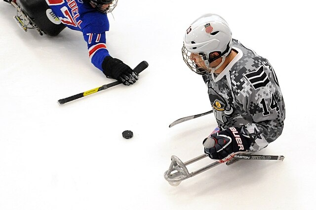    San Antonio Rampage forward Joshua Sweeneey manuevers past Navy veteran Ian Ramsdell of the USA Warriors during a sled hockey game in Rockville, Md. Sept. 18, 2014. Sweeney scored the winning goal of the gold medal sled hockey round in the 2014 Paralympics in Sochi. (DoD News photo by EJ Hersom) Василий Соколов
