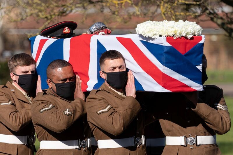    The coffin of Captain Sir Tom Moore is carried by members of the Armed Forces during his funeral at Bedford Crematorium, amid the coronavirus disease (COVID-19) outbreak, in Bedford, Britain February 27, 2021. Joe Giddens/Pool via REUTERS