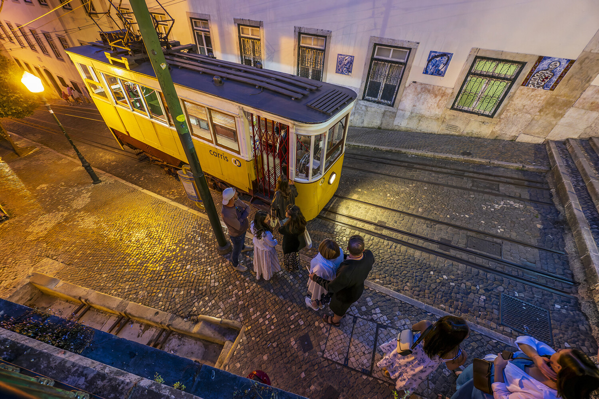 Туристы и местные жители стоят в очереди, ожидая посадки в кабинку фуникулера Gloria, Лиссабон, Португалия, 2023 год    📷