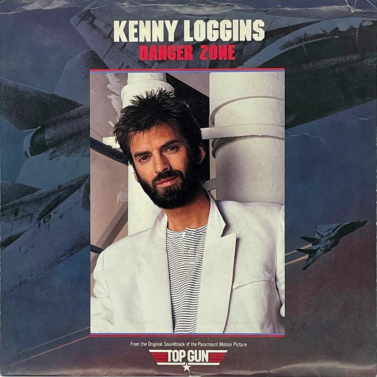 Обложка композиции «Danger Zone». Исполнитель — Кенни Логгинс (листайте дальше, чтобы увидеть еще)