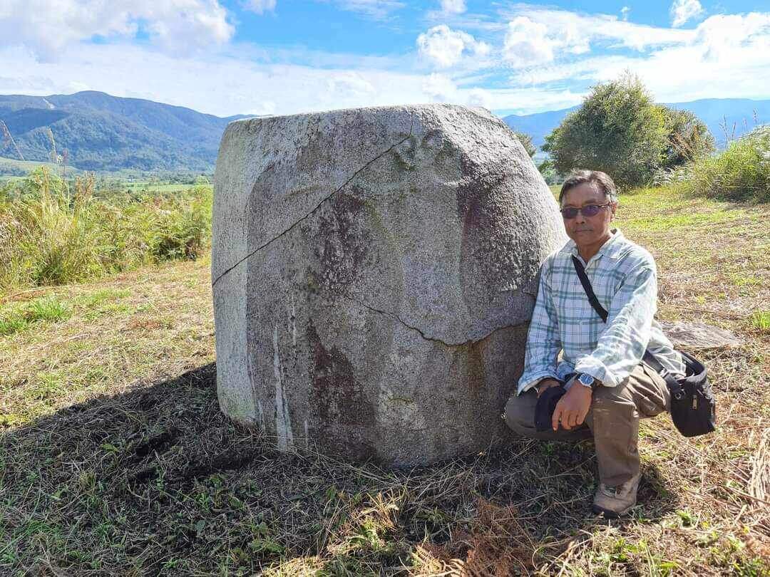 Доктор Дэни Хилман Натавиджаджа у огромного гранитного сосуда с изображением пришельца на острове Сулавеси, Индонезия