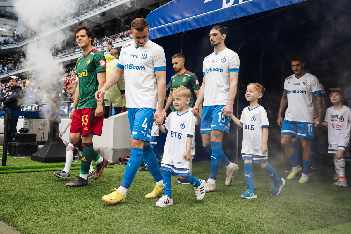 Футболисты вывдят детей на поле