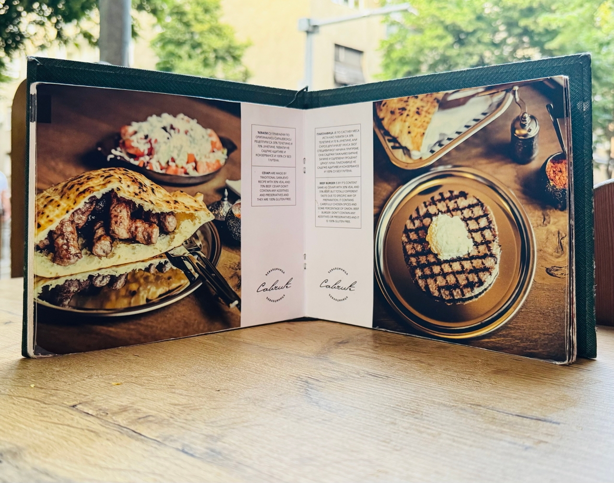 В меню на фоне чевапчичей видно еще одно национальное блюдо - шопский салат