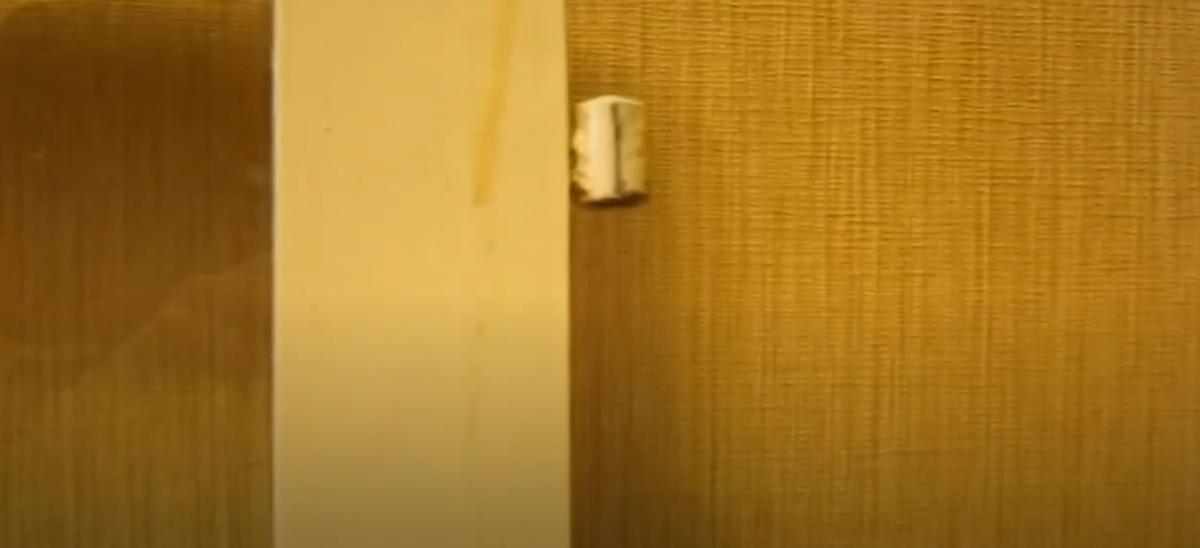 Ввёртная петля на деревянной раме окна 