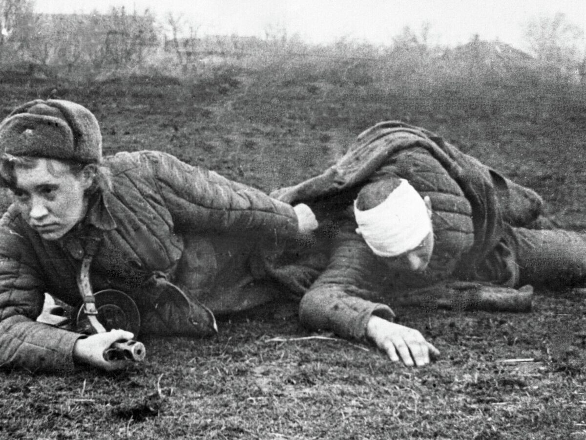    Санинструктор Валя Грибкова эвакуирует раненого с поля боя© РИА Новости