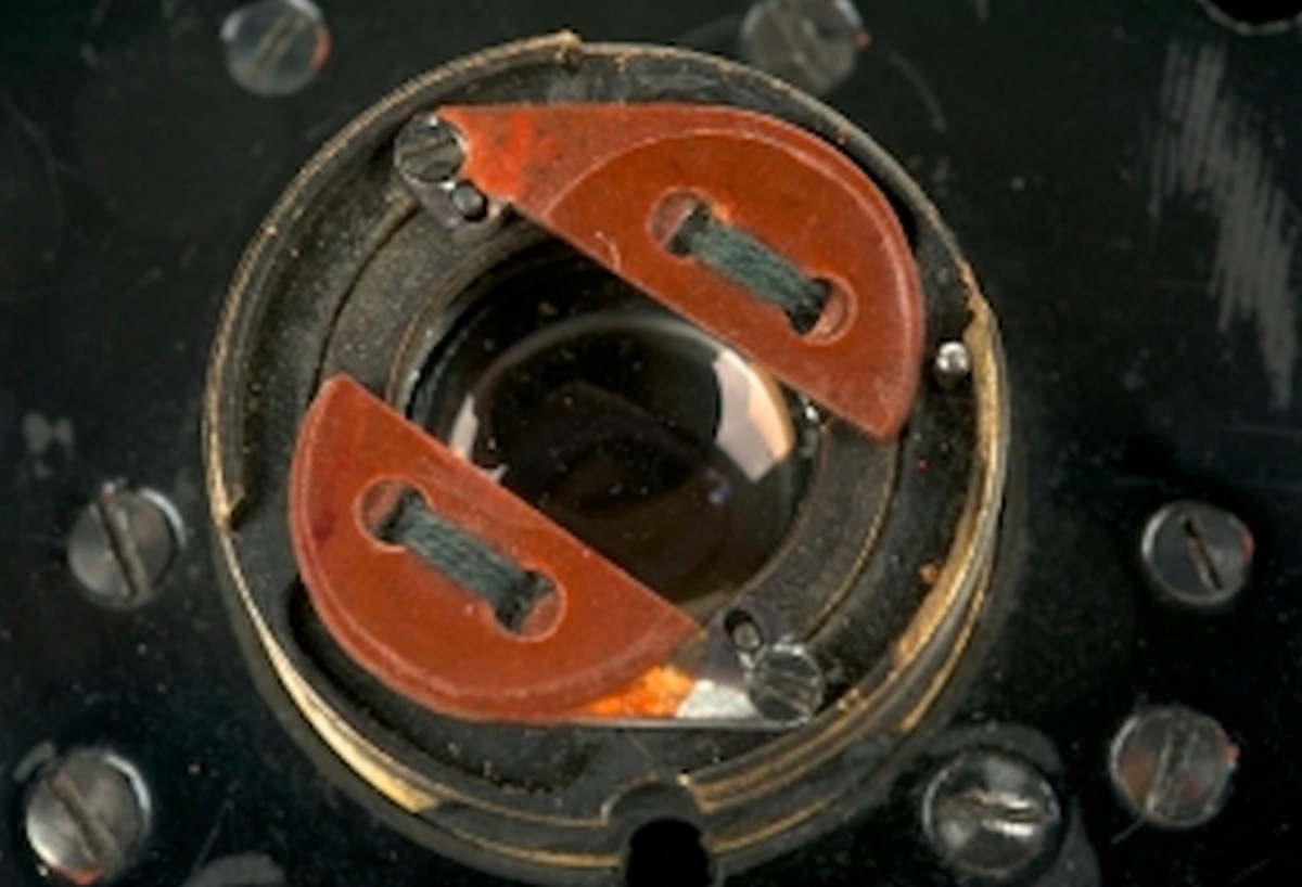 Объектив, спрятанный за пуговицей. Раздвижение пуговицы синхронизировалось с движением затвора и было почти незаметно для человеческого глаза. Обратите внимание, как достоверно выполнена сама пуговица