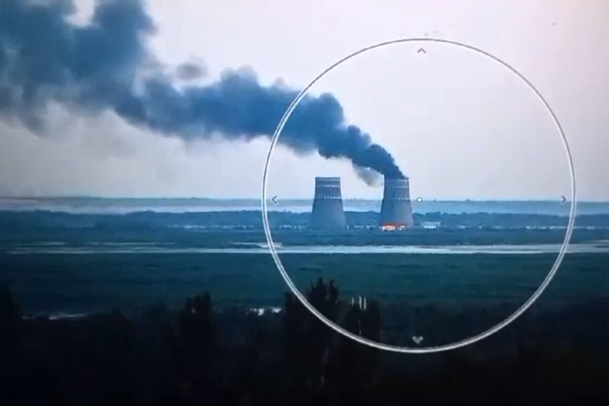    This video grab taken from a handout footage released by the Ukrainian Presidential Press Service on August 11, 2024, shows a fire at a cooling tower of the Russian-controlled Zaporizhzhia nuclear power plant in Energodar, Southern Ukraine. (Photo by Handout / UKRAINIAN PRESIDENTIAL PRESS SERVICE / AFP) / RESTRICTED TO EDITORIAL USE - MANDATORY CREDIT "AFP PHOTO / UKRAINIAN PRESIDENTIAL PRESS SERVICE" - NO MARKETING NO ADVERTISING CAMPAIGNS - DISTRIBUTED AS A SERVICE TO CLIENTS