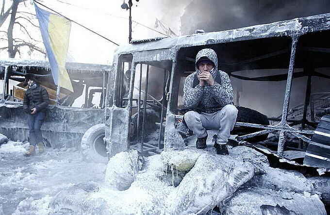   Anti-government protesters gather at a barricade at the site of clashes with riot police in Kiev January 25, 2014. Ukrainian President Viktor Yanukovich, in what appeared to be an offer of concessions to the opposition amid violent protests against his rule, pledged on Friday to reshuffle the government next week and to amend sweeping anti-protest laws. REUTERS/David Mdzinarishvili (UKRAINE - Tags: POLITICS CIVIL UNREST)