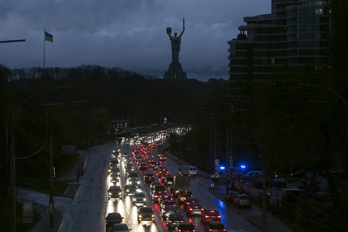    Cars drive on a dark street with a Monument Motherland on the background during a blackout after a Russian missile attack on Ukrainian power infrastructure in Kyiv, Ukraine, November 03, 2022 (Photo by Maxym Marusenko/NurPhoto via Getty Images)