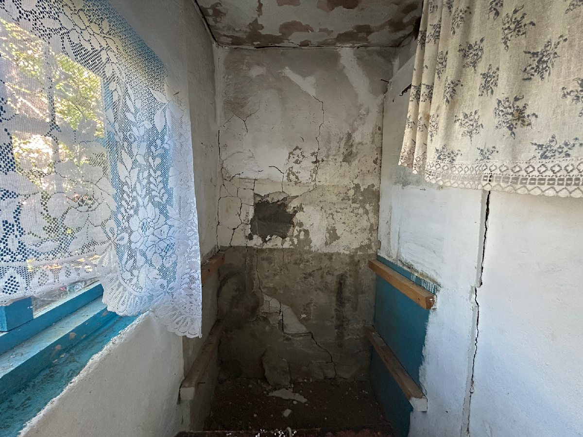 Штукатурка на дальней стене отвалилась, потому что крыша в этой части дома протекала 