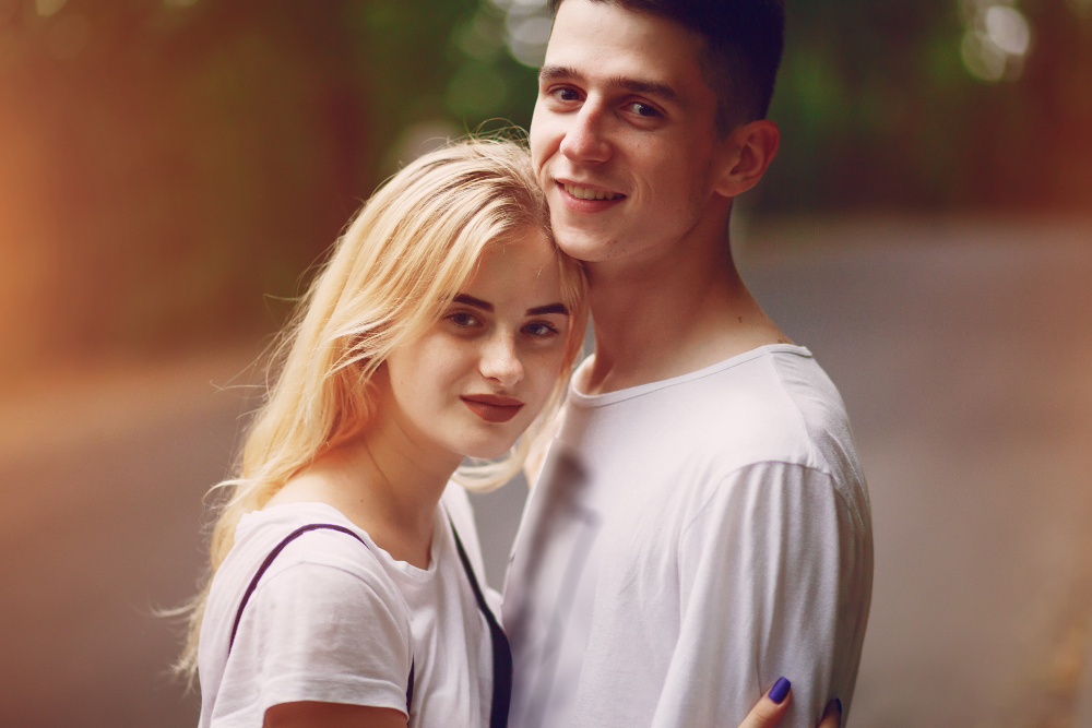 Молодая пара обнимается и улыбается — признак доверия и эмоциональной близости в отношениях
