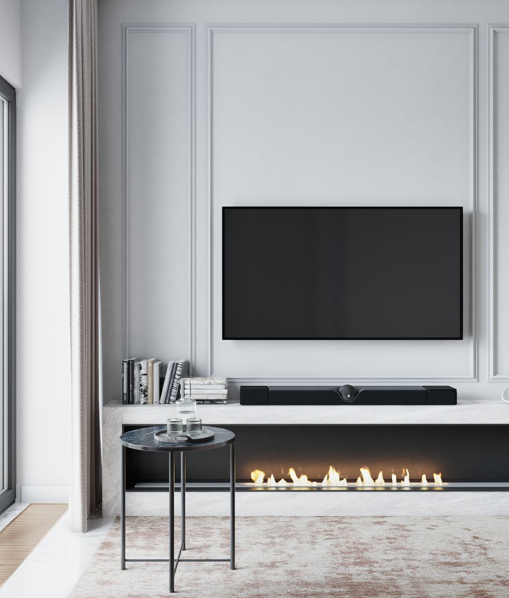 Комфортный центр квартиры: уютная зона отдыха с камином и мягким диваном в нейтральных тонах создаёт атмосферу дома, где приятно проводить вечера.