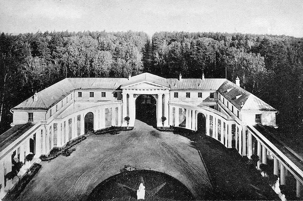 Вид с бельведера Большого дворца на Парадный двор, Императорскую аллею и рощу Быкушу. Начало ХХ века. Фотография П. Павлова. На фотографии слева — Западный флигель, где располагалась Каретная галерея. Цветокоррекция автора статьи.