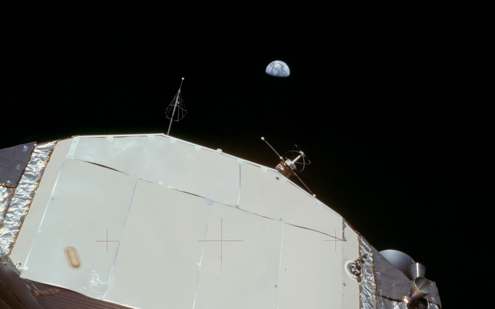 На фото NASA Земля на небосводе над лунным модулем