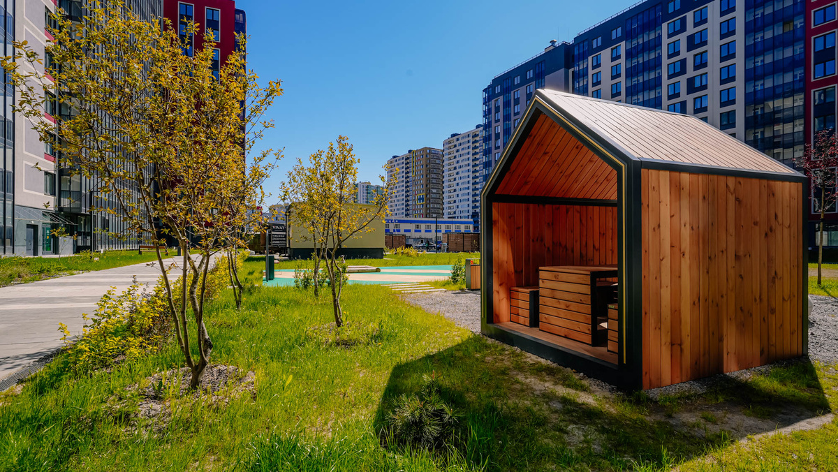 Двор первого корпуса жилого комплекса «Полис Лаврики» в Мурино: здесь очень уютно и зелено.