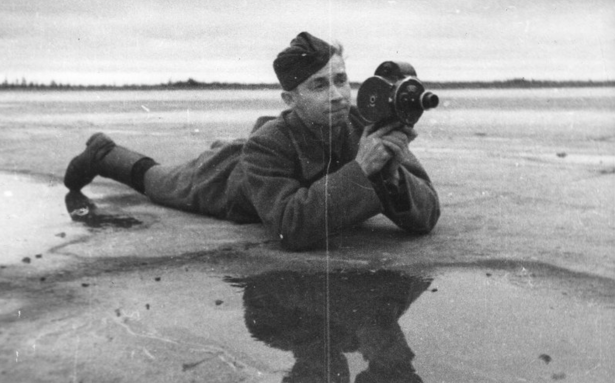 Бобров Георгий Макарович. Фотография. Фронтовой оператор Павел Касаткин. 1941. Госкаталог. Федеральное государственное бюджетное учреждение культуры "Государственный центральный музей кино". На первом плане, лежащий на льдине оператор П.Касаткин с ручной кинокамерой в руках
