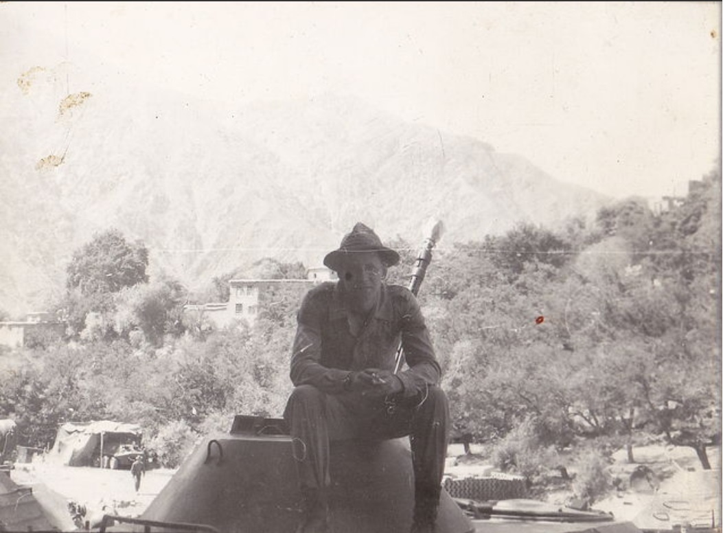 На фото Семён Быстров в боевом охранении. На заднем плане виден БТР, каркас и масксеть.