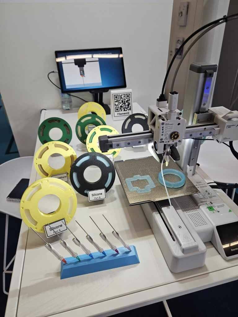 Процесс печати силиконовым «филаментом» на доработанном бытовом принтере. Обратите внимание на конструкцию сопел и трубочку, выходящую из сопла. Судя по одной трубке – печать в данном случае ведется однокомпонентным материалом.