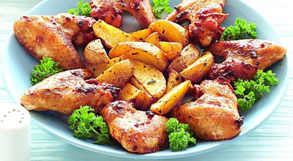 Предлагаю рецепт простого, сытного и вкусного блюда - куриных крылышек, запечённых с картошкой в духовке. Крылья  предварительно маринуем, картофель варим до полуготовности. Поэтому после запекания крылышки получаются румяными, сочными, а картошка - мягкой, аппетитной, да ещё и хорошо пропитавшейся куриным соком. В качестве дополнения к этому блюду можно подать любимый соус или нарезанные свежие овощи