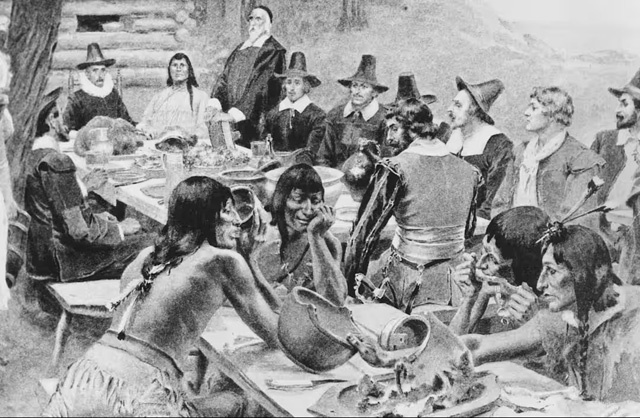 Первых поселенцев Плимутской колонии, разделяющих урожай во время празднования Дня благодарения с местным населением племени вампаноагов