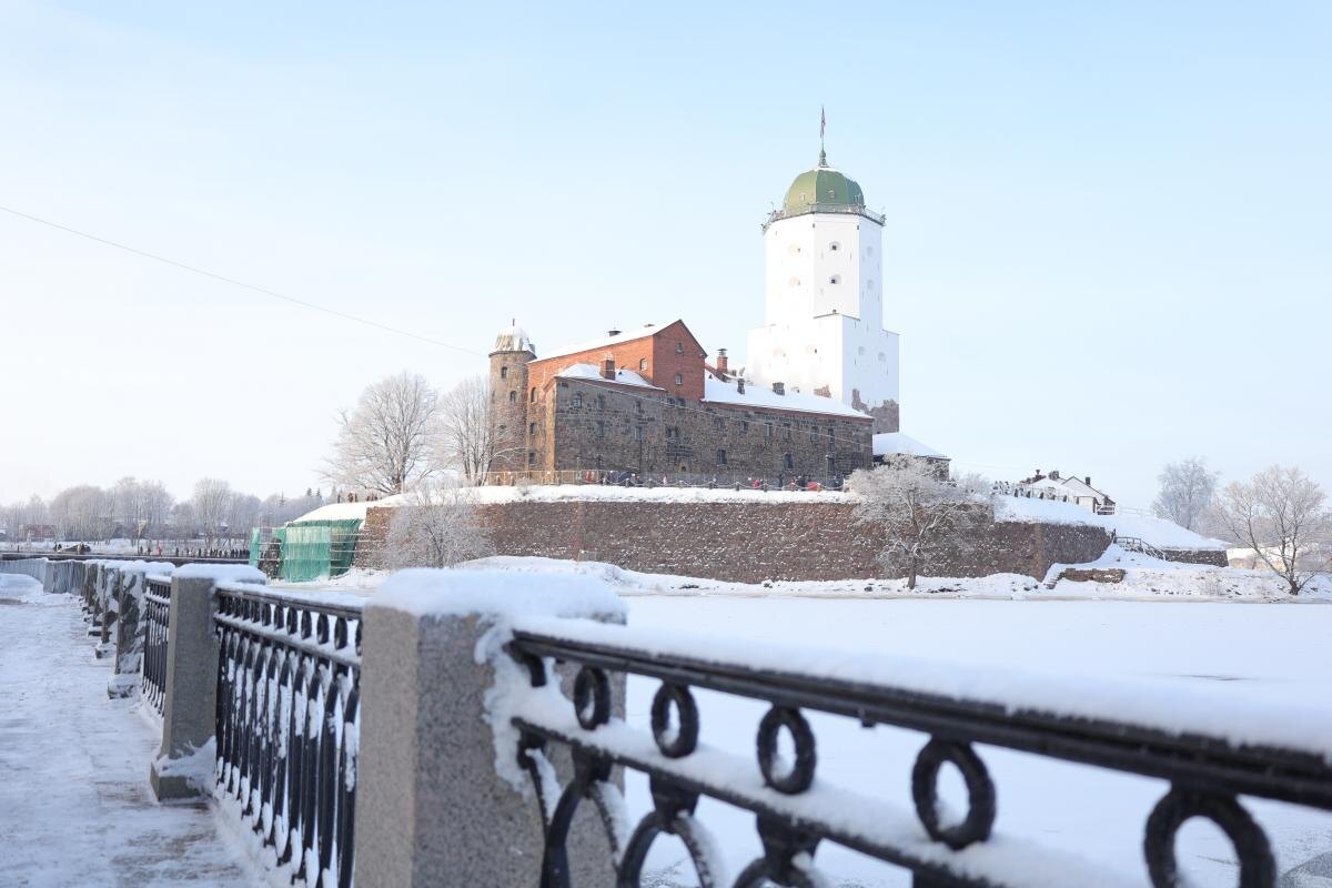 Выборгский замок зимой вид с набережной, лед на воде.
