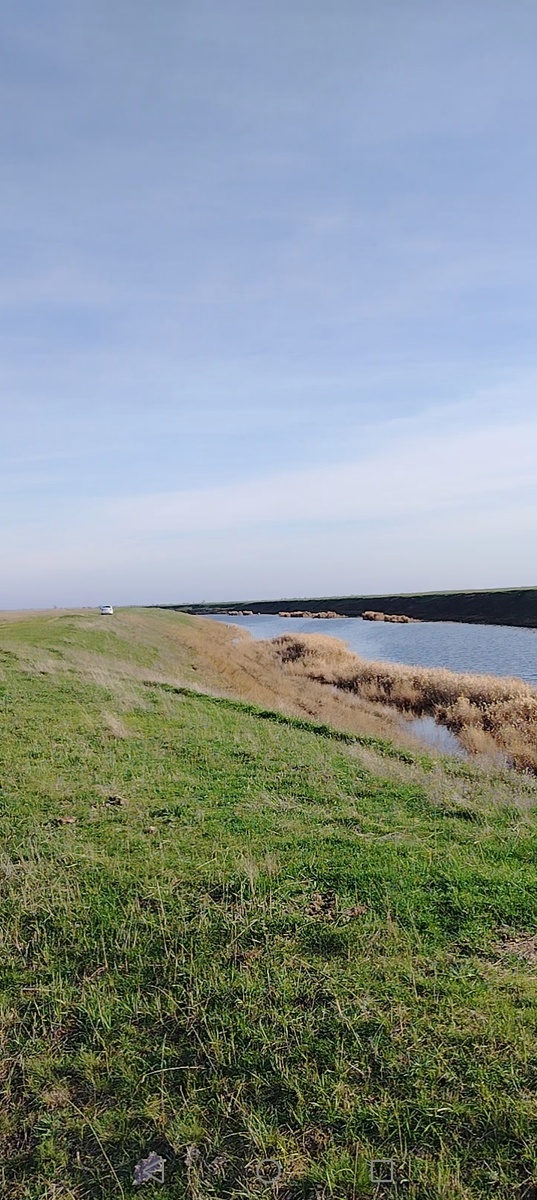 Река переливается серебристой рябью от теплого осеннего ветерка.
