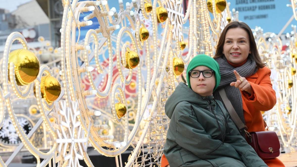    Елена Наумова с сыном Максимом любуются новогодним оформлением столицы / Фото: Пелагия Замятина / Вечерняя Москва