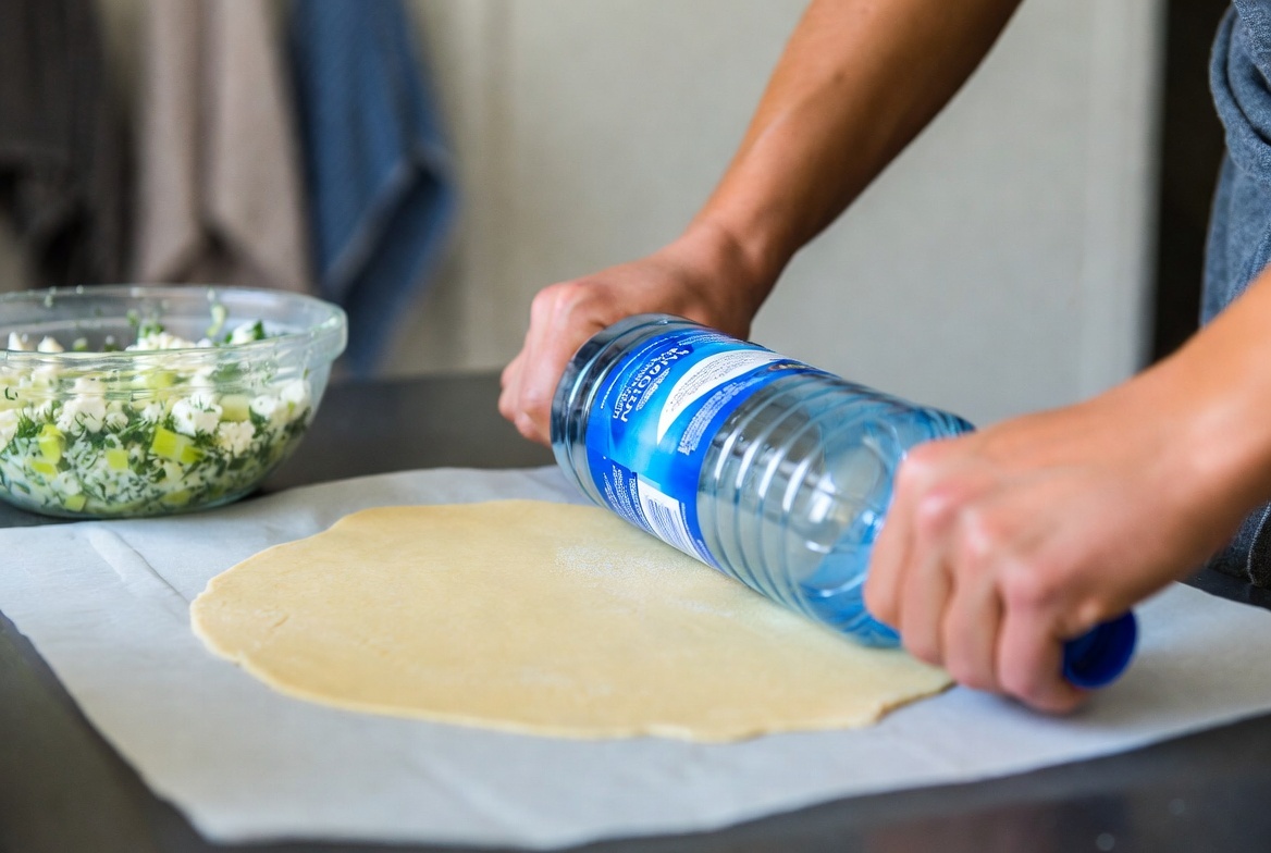 «Скалка — не обязательна. Бутылка с водой — идеальный вес: не мнёт, не рвёт, даёт равномерную толщину. Главное — поворачивать тесто каждые 30 секунд»