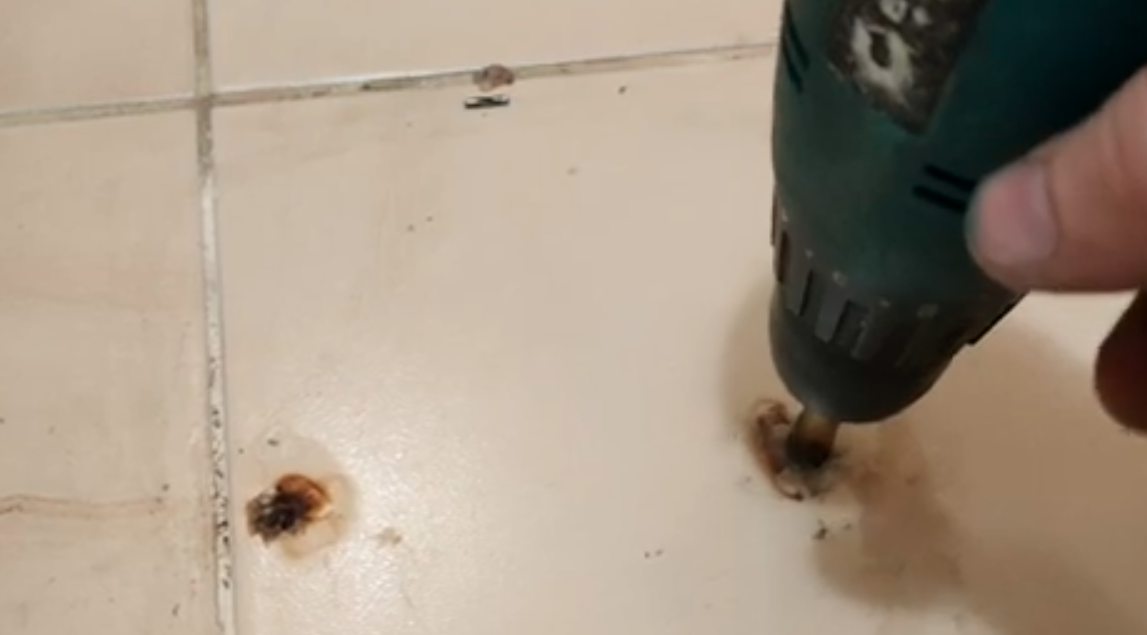 Дрелью и анкером высверливаем пластмассовую пробку.