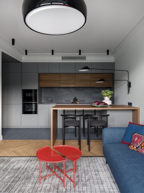 Вид на зонукухни. Минималистичная кухня в сером цвете, Leicht. Варочная панель, духовойшкаф, микроволновка, Neff. На полу — инженерная доска Finex.