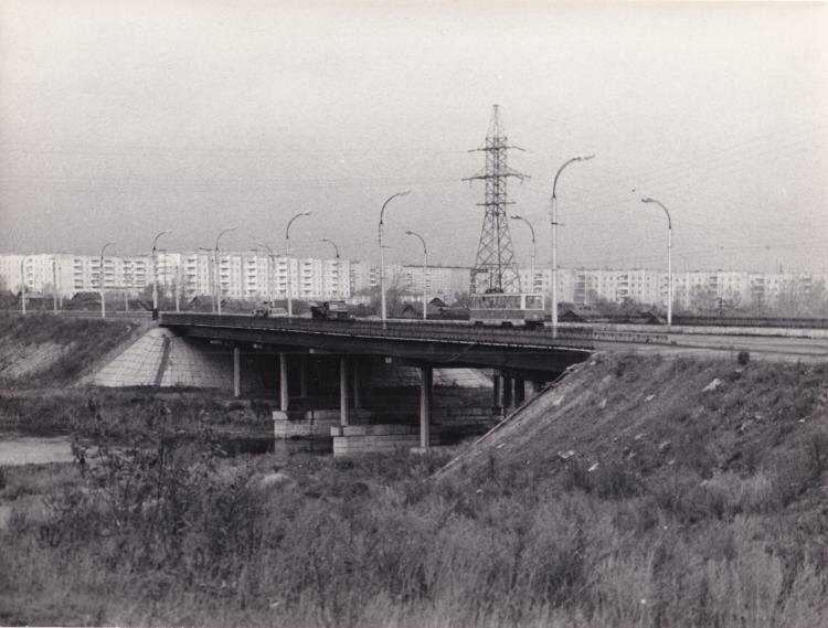 Мост через реку Тагил, соединяющий два жилых района, Выю и Красный Камень. На снимке железобетонный мост с идущим по нему трамваем и грузовым автомобилем. 1983 год