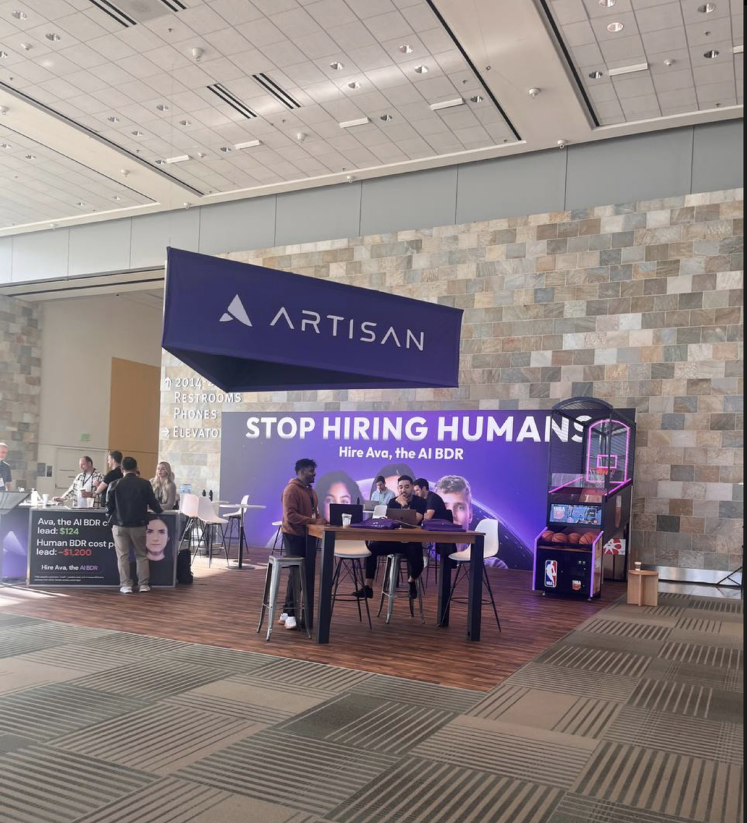 Стэнд компании Atisan AI, разработчика ИИ-агентов:  "Прекратите нанимать на работу людей".