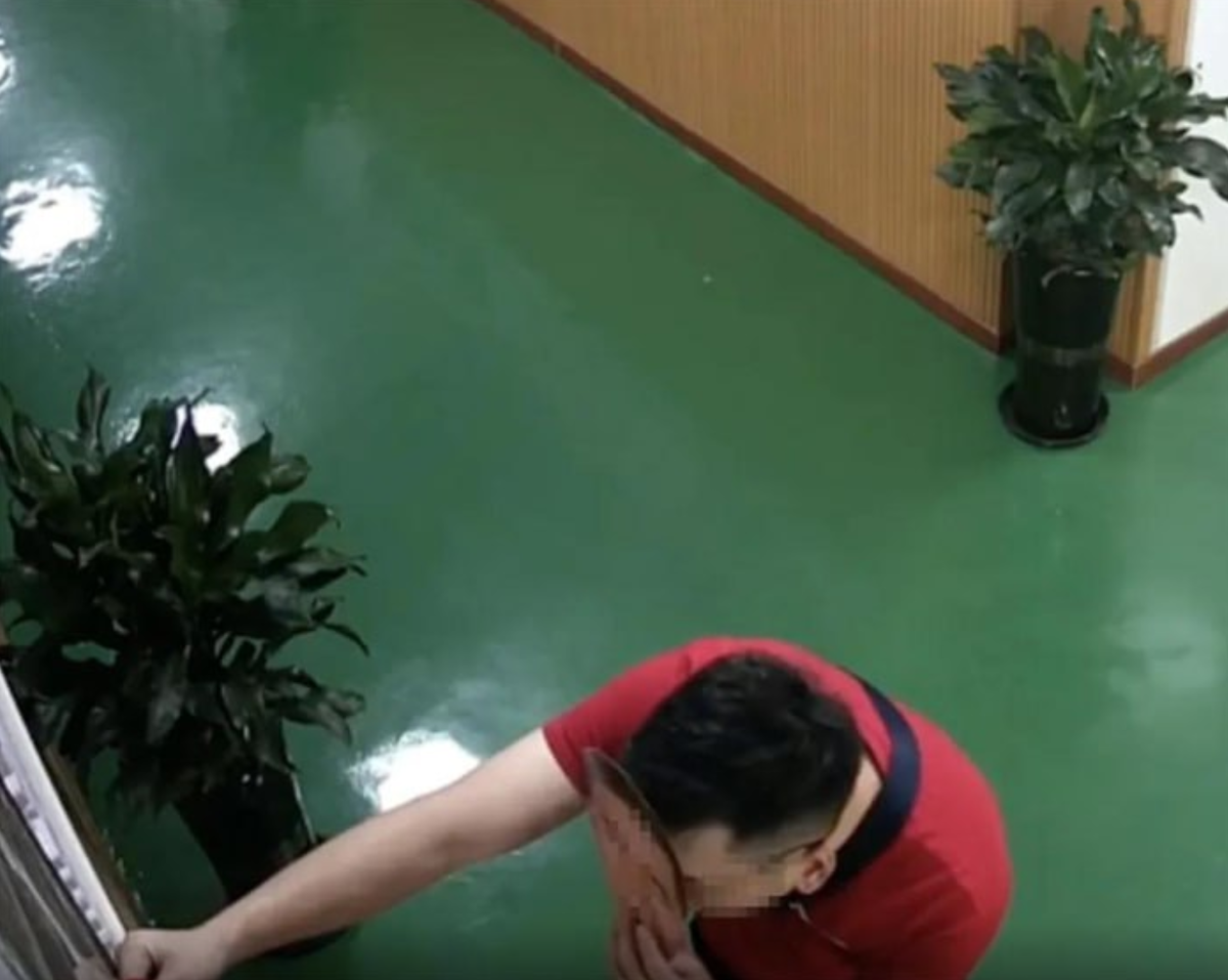    Китайский чиновник надевает маску на контрольном пункте