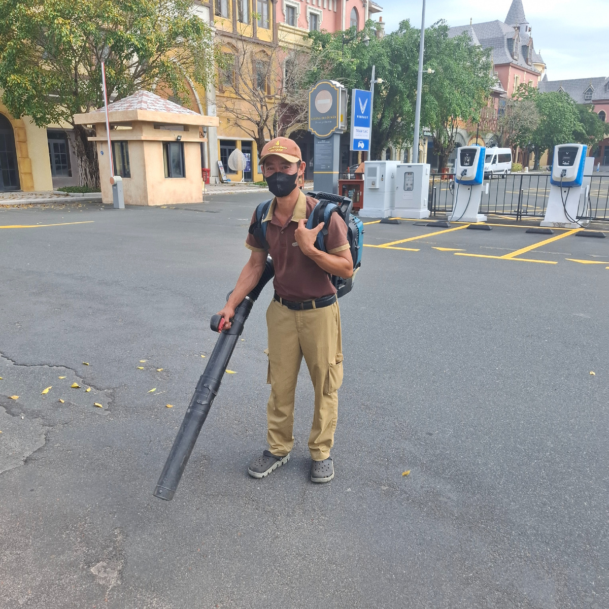 Типичный служащий индустрии развлечений - убирает мусор на парковке перед парком.