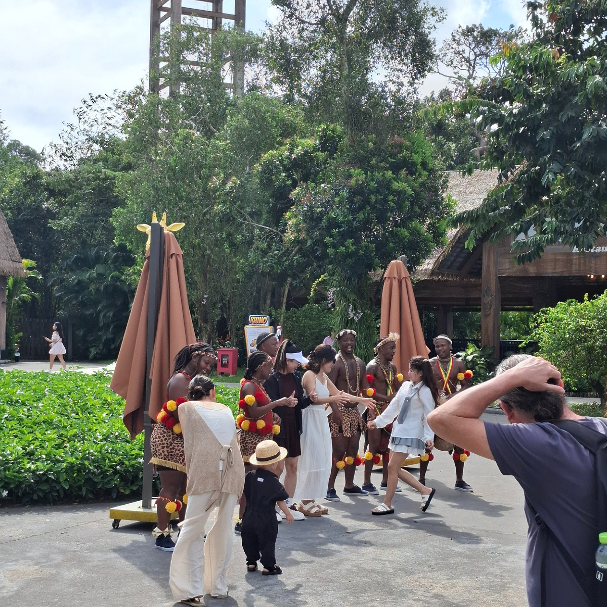 Группа африканских танцоров и певцов перед входом в парк.