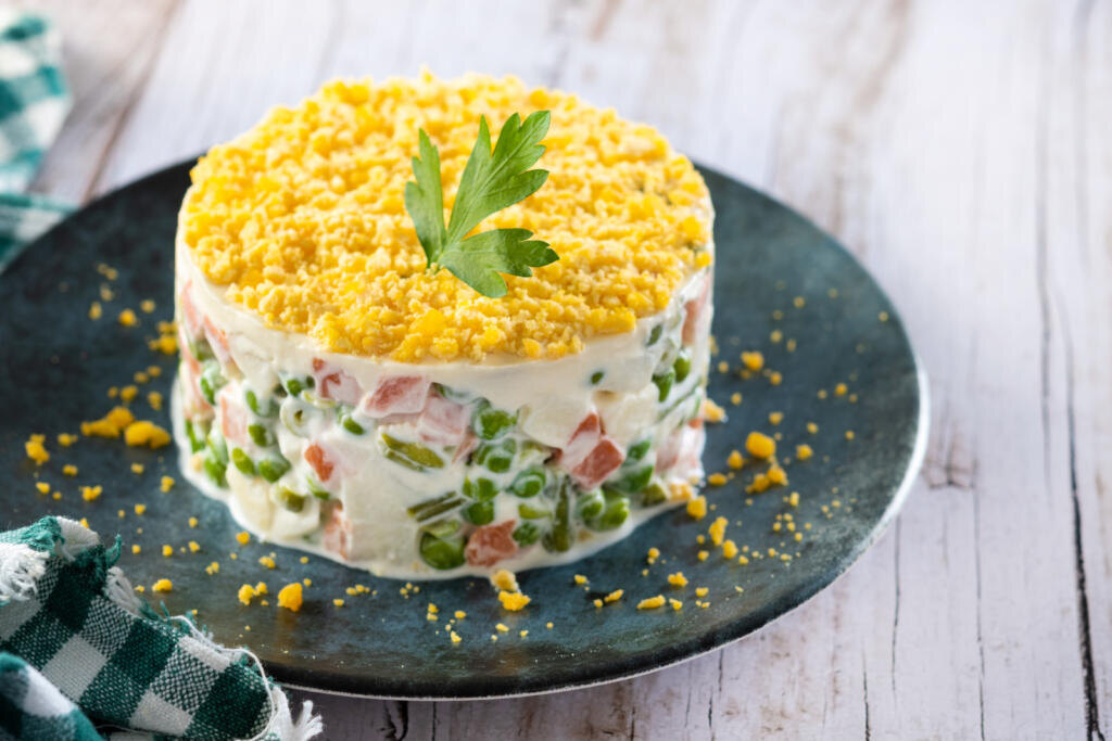    Russian salad or Olivier salad for Christmas dinner on wooden table Журналист