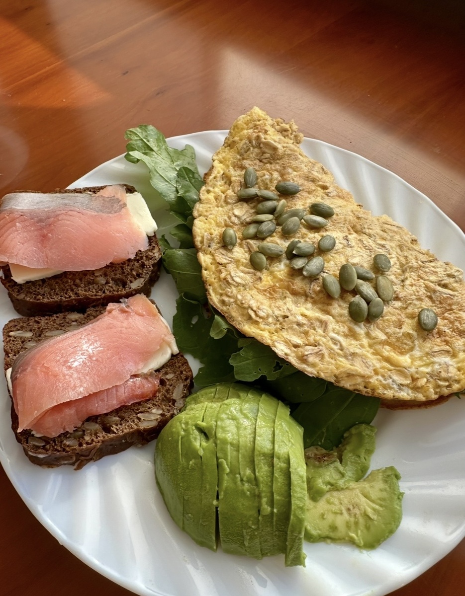 Зерновой бутерброд с  соленой форелью, авокадо, овсяноблин с рукколой и тыквенными семечками.