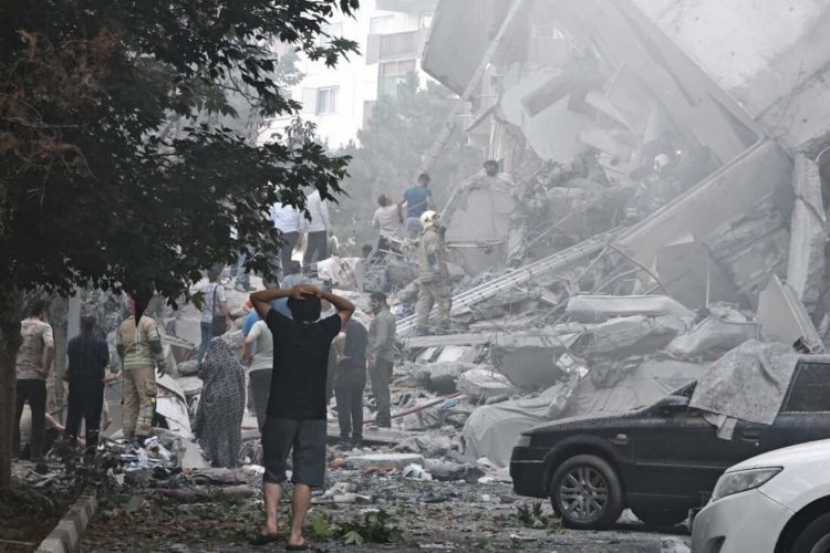    TEHRAN, IRAN - JUNE 13: People look over damage to buildings in Nobonyad Square following Israeli airstrikes on June 13, 2025 in Tehran, Iran. Iran's three top military generals were killed in the attacks that also targeted nuclear and military facilities, according to published reports. Israel described the strikes as preemptive to keep Iran from obtaining nuclear weapons, the reports said. (Photo by Majid Saeedi/Getty Images) Nare
