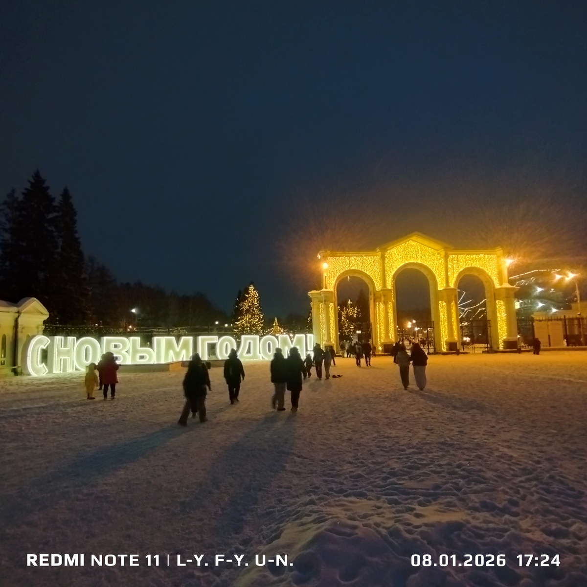 Арка в стиле советского конструктивизма украшена подсветкой. На входе слева поздравление горожан и гостей города.