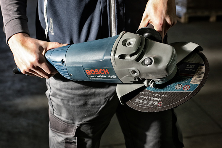 Мужчина с УШМ Bosch GWS22-230H в руках. Фото с сайта https://www.lineonline.it/