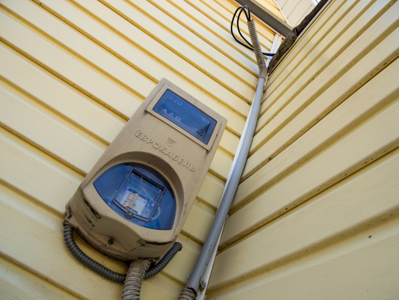 Счетчик электроэнергии на фасаде дома