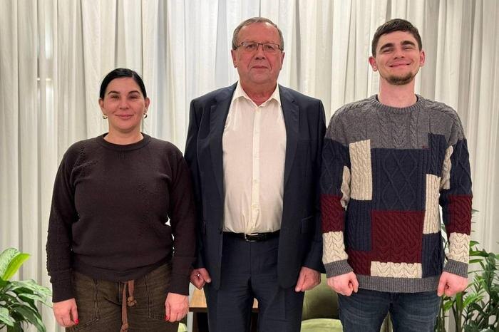 Максим Харкин (справа), его мама Наталья (слева) и посол РФ в Тель-Авиве Анатолий Викторов (в центре). Обложка © Посольство России в Израиле