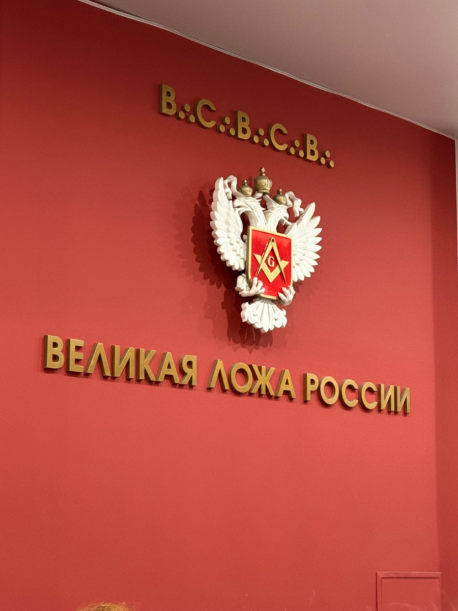 Вход в ложу. Аббревиатура означает «Во славу Великого Архитектора Вселенной» под коим подразумевается Господь.