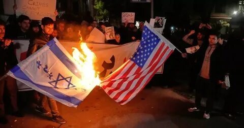 Деомнстранты в Тегеране сжигают флаги США и Израиля. Фото Яндекс. Картинки. 